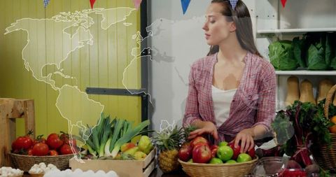 Young Woman Arranging Vibrant Fresh Produce at Market Stall