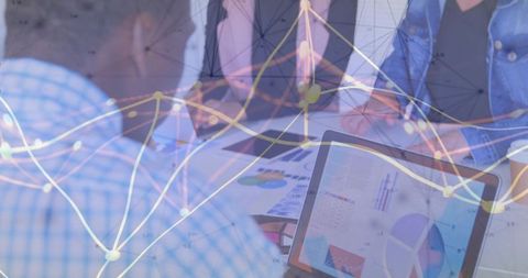 Business Team Analyzing Financial Charts on Laptop with Digital Network Data Overlay