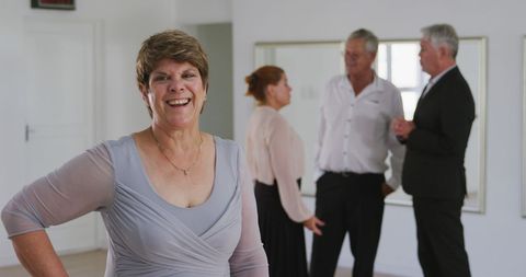 Happy mature woman at ballroom dance class