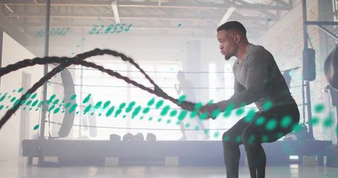 Man Training with Battle Ropes in Urban Gym
