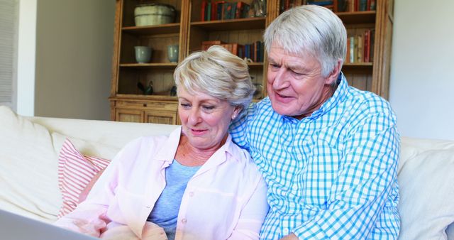 Senior Couple Using Laptop on Living Room Sofa - Download Free Stock Images Pikwizard.com