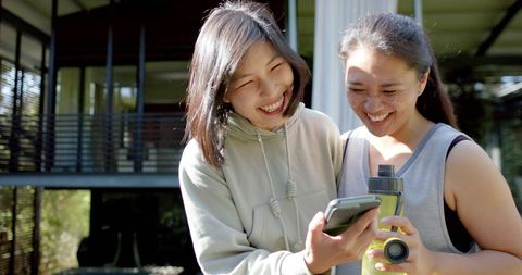 Joyful Asian Friends Sharing Moments Together Outdoors