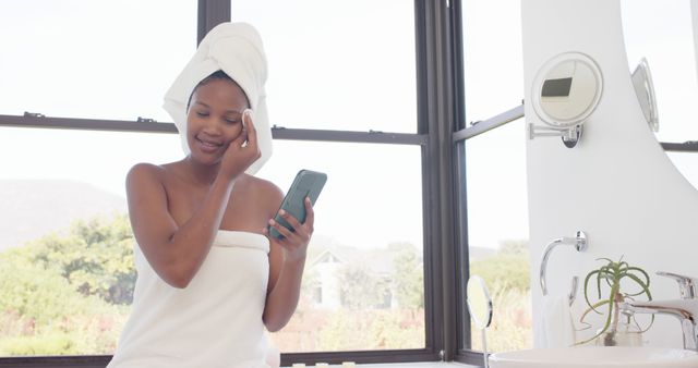 Smiling Woman in Towel Using Smartphone Near Bathroom Window - Download Free Stock Images Pikwizard.com