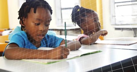Young Student Focused on Classroom Writing Activity