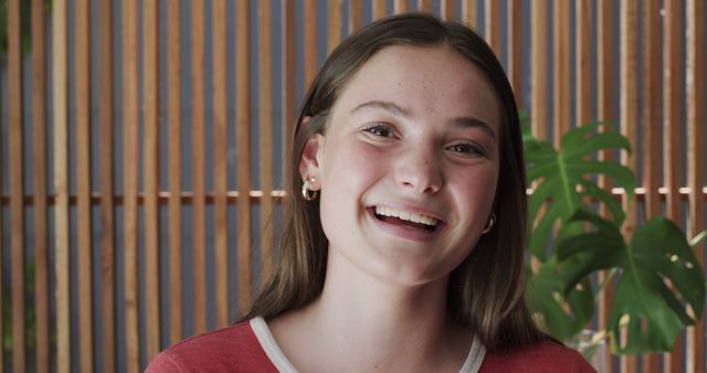 Smiling Teen Girl with Brown Hair and Hoop Earrings - Download Free Stock Images Pikwizard.com