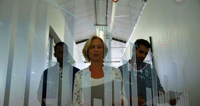 Team Analyzing Financial Charts in Corporate Hallway