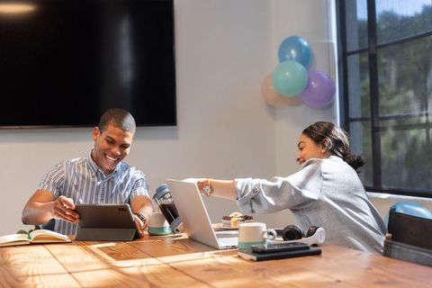 Casual Teamwork in Modern Office Environment with Balloons