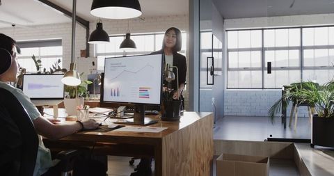 Team Collaboration with Digital Charts in Modern Office