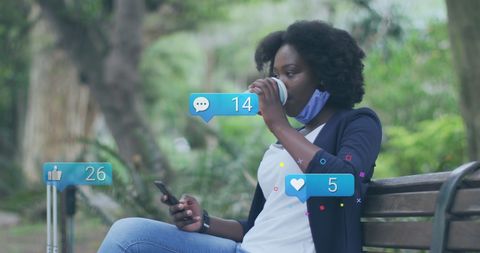 Woman Engaging with Social Media Icons While Using Smartphone Outdoors