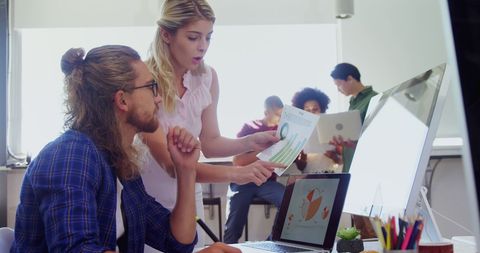 Young Professionals Collaborating in Bright Office Space