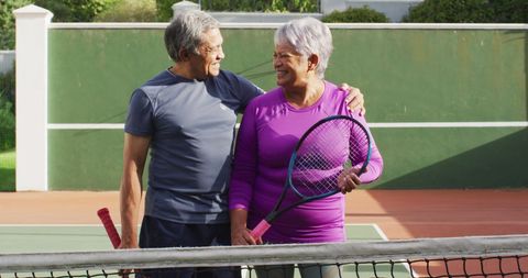 Happy Senior Couple Enjoying Tennis at Court