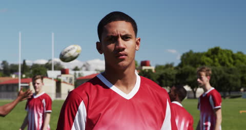 Teenage Rugby Player Focused on Field with Teammates