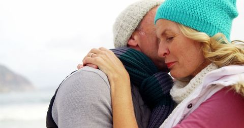 Mature Couple Embracing Tenderly on Winter Beach
