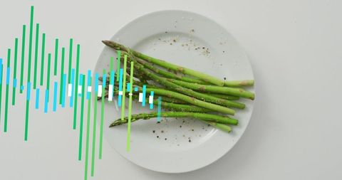 Green asparagus on white plate with colorful sound wave overlay, minimalist food concept