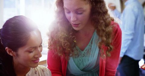 Professional Women Collaborating in Bright Office Space