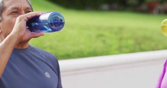 Elderly Person Hydrating Outdoors with Fresh Water - Download Free Stock Images Pikwizard.com