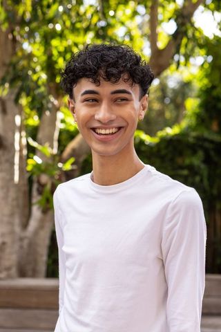 Smiling Man Relaxing Outdoors in Sunny Garden