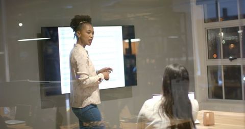 Businesswoman Presenting Key Research in Late Night Office Meeting