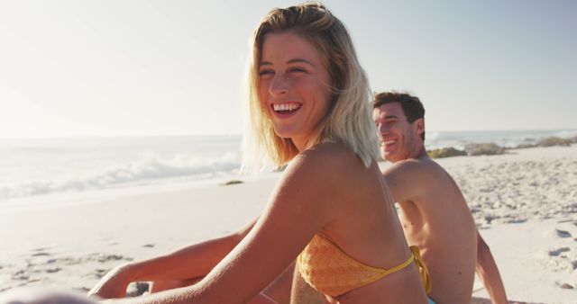 Couple Enjoying Sunny Day at Beach with Smiles - Download Free Stock Images Pikwizard.com