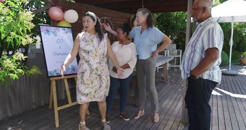 Friends Celebrating Anniversary with Congratulatory Sign