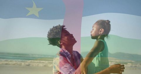 Joyful Mother and Daughter at Beach with Overlaid Flag