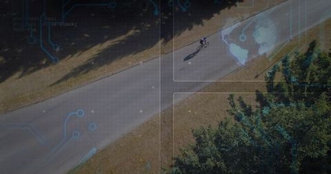 Aerial teen cyclist pedaling on park path with ar overlays and tree canopy