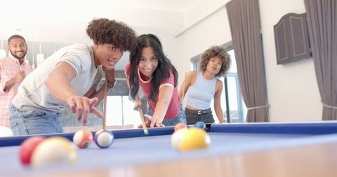 Diverse Friends Having Fun Playing Indoor Pool