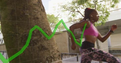 Woman sprinting through urban plaza wearing pink bra and leggings with green fitness data overlay