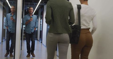 Business Professionals Walking in Modern Office Hallway