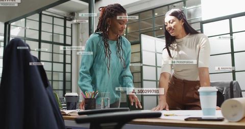 Creative Designers Collaborating on Blueprints in Modern Office