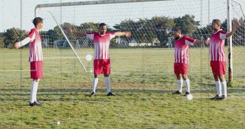 Four-player defensive wall practicing free-kick drill on community soccer field