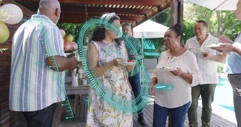 Multigenerational friends mingling at poolside backyard party with futuristic HUD overlay