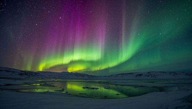 Glowing aurora borealis painting starry sky over arctic plain reflecting on lagoon