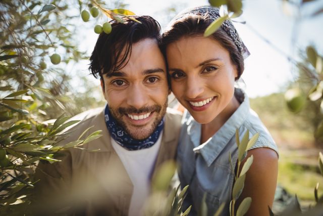 Portrait of smiling young couple by olive trees at farm - Download Free Stock Photos Pikwizard.com