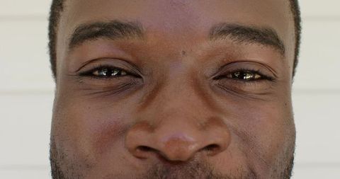 Close-up African American Man Smiling and Gazing Soft Natural Lighting Stubble Headshot