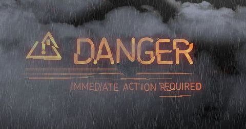 Amber danger warning glowing over stormy sky with immediate action required alert
