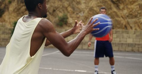 Basketball Players Training Passionately on Outdoor Court