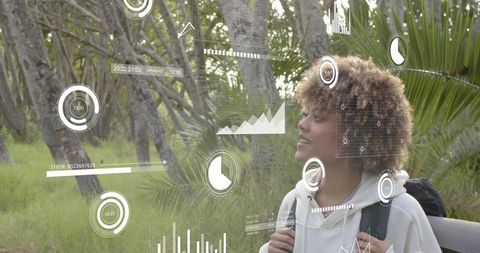 Woman exploring trail wearing backpack viewing augmented reality data overlays