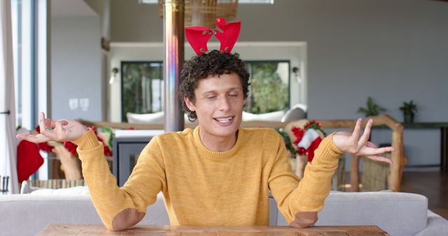 Young Man with Holiday Antlers Sitting Indoors - Download Free Stock Images Pikwizard.com