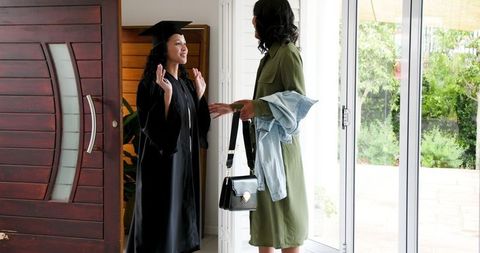 Graduate Celebrating Success with Proud Mother at Home