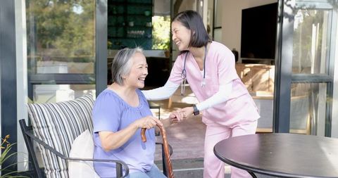 Caring senior woman outdoor healthcare support nurse assists