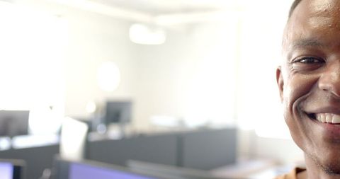 Confident Businessman Smiling In Sunny Office Environment