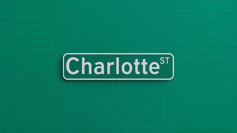 Minimalist white charlotte street sign 'charlotte st' on green background
