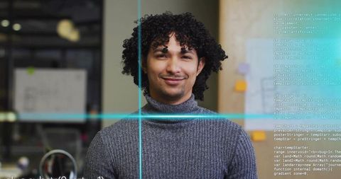 Smiling developer coding in modern office with digital code overlay and team workspace