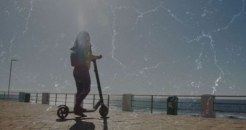 Woman Riding E-Scooter Along Seaside Promenade