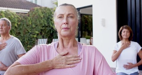 Senior adults practicing mindful breathing outdoors together