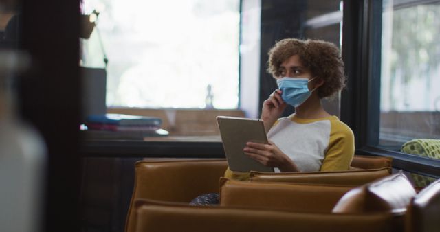 Woman Wearing a Face Mask Working on Digital Tablet in Office - Download Free Stock Images Pikwizard.com