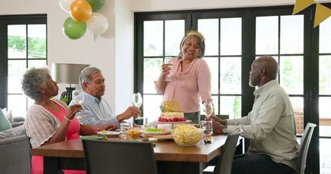Senior Friends Celebrating Birthday Together with Toast