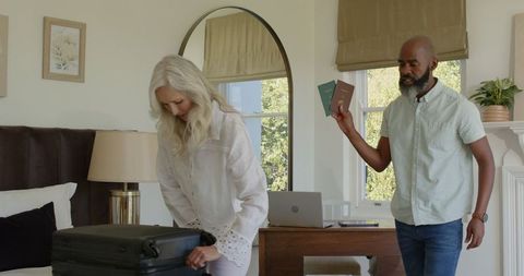 Couple Packing Suitcase for Joyful Wedding Day Getaway