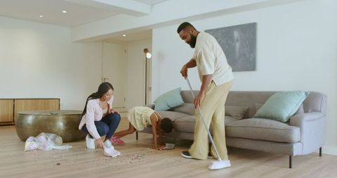 Family cleaning together in cozy living room